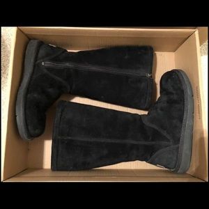 Tall black Ugg boots with zipper.